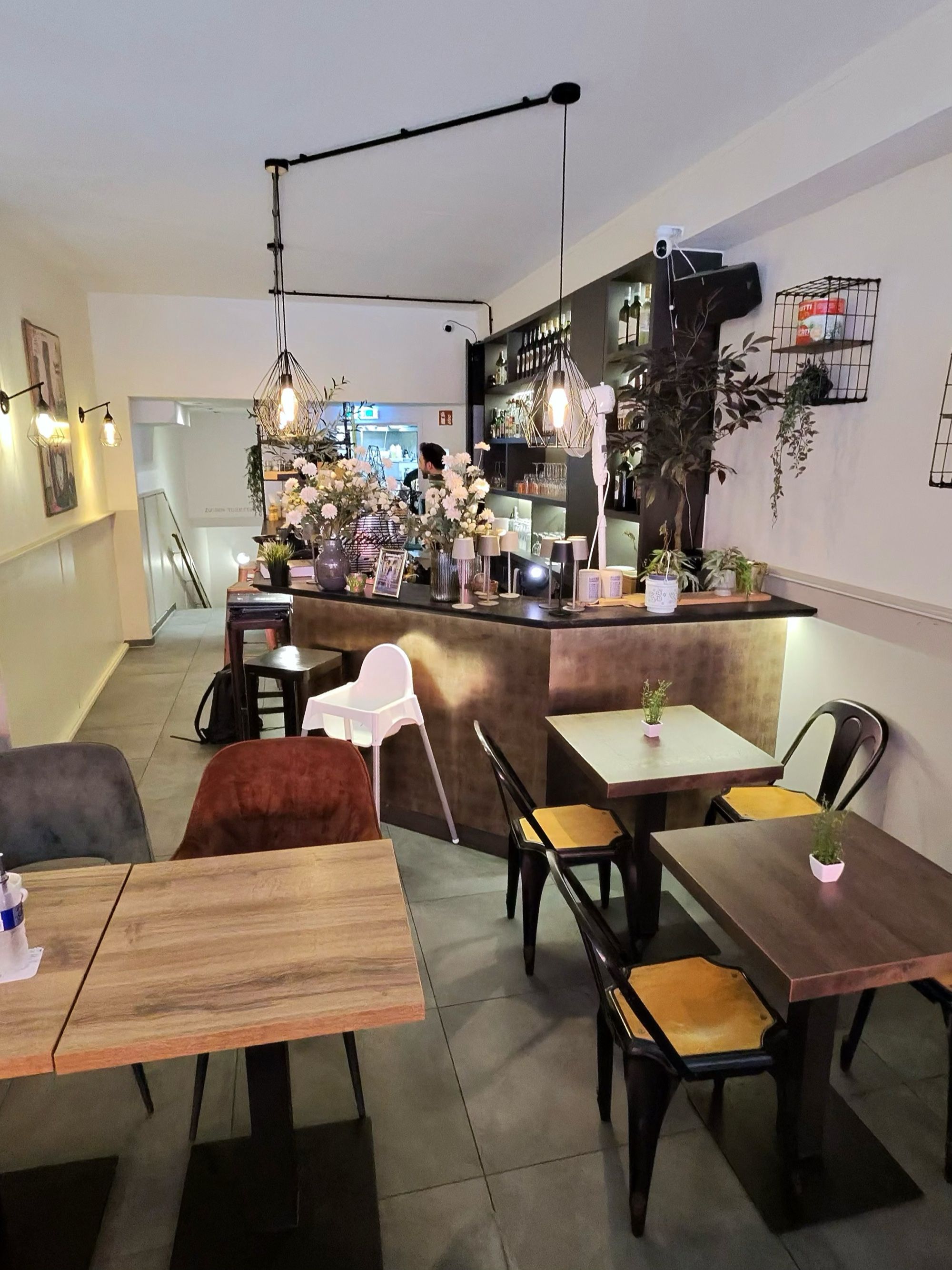 Bar-Bereich mit warmem Licht und Blumen bei Sorry Mama Köln